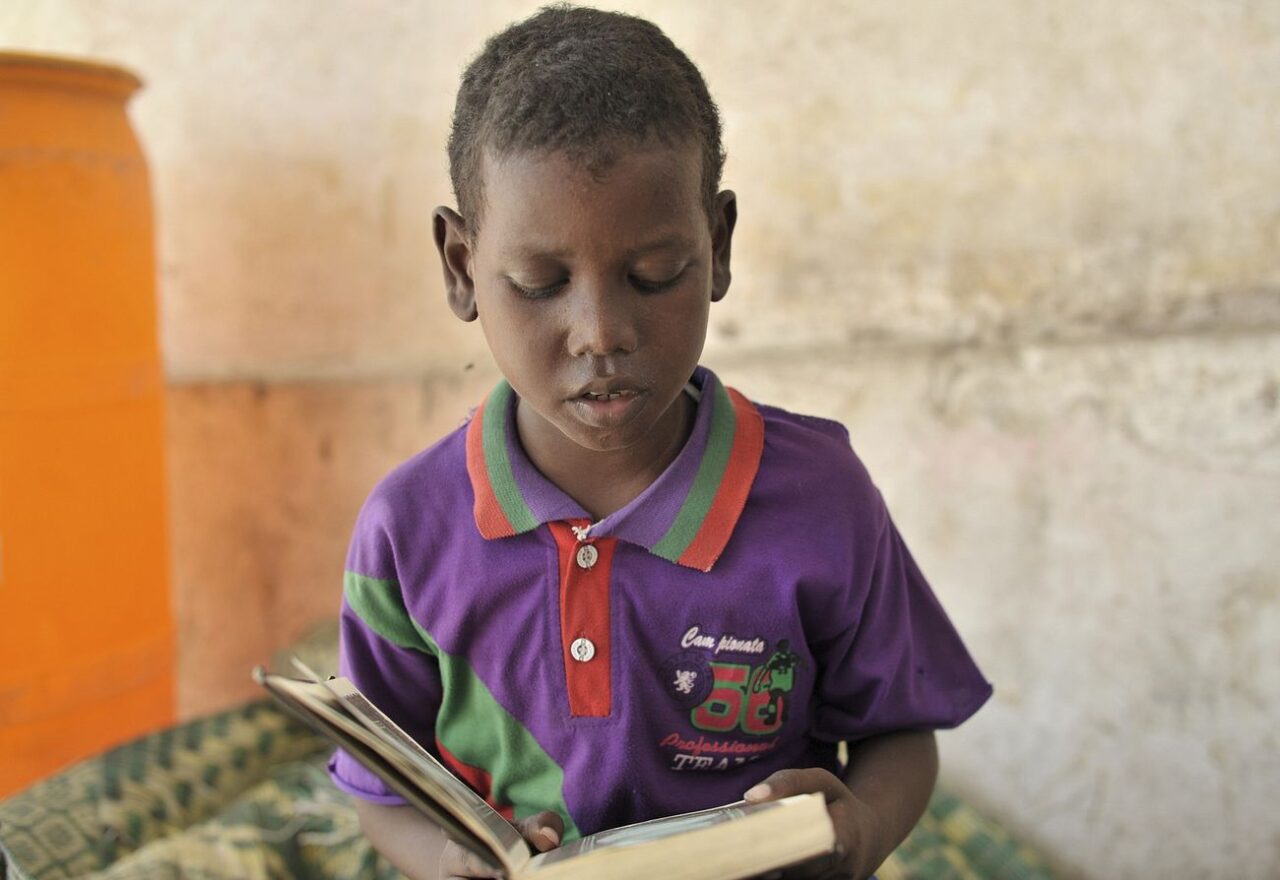 A young boy reads the holy